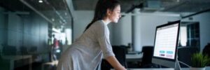 A woman works at a standing desk