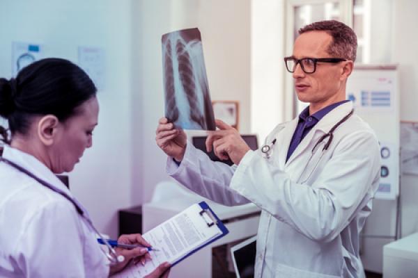 A doctor looks at an X-Ray in a hospital